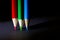 Macro Shot of Red, Green and Blue Sharpened Colorful Pencils Against Black Background