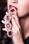 Macro shot. Red lips with jewelery pendant