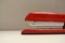 Macro shot of red stapler in an office setting