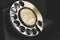 Macro shot rotary dial on grungy, old telephone phone