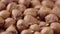 Macro shot of the rotating peeled hazelnuts. Dried brown hazel kernels close up. Organic healthy food background. Slow