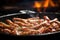 macro shot of sausage sizzling on a stovetop pan