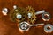 A Macro shot of several small stainless steel bolts, washers and nuts with an eyelet wood screw and various brass miniature gears,