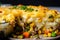 Macro shot of a Shepherd Pie with layers of mashed potatoes, seasoned beef, carrots, peas, and corn