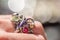 Macro shot of silver engagement ring on colorful, sparkling background