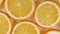 Macro Shot of Sliced Orange Fruit Slices and Rotate. Orange Fruit Pattern. Healthy Food Background. Slow Motion.