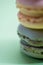 Macro shot of stack of macarons over green mint background