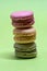 Macro shot of stack of macarons over green mint background