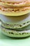 Macro shot of stack of macarons over green mint background