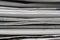 Macro shot of a stack of newspapers. The newspapers are folded