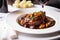 Macro shot of succulent Coq au Vin, a traditional French dish with a rich red wine sauce, served on a white porcelain plate