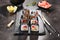 Macro shot of sushi roll in Japanese restaurant with chopsticks closeup. Sushi rolls with rice, fried salmon, flying fish caviar,