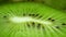 Macro shot of a water drop fallin on kiwi slice