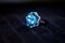 Macro shot of a white precious metal ring with big blue gem