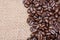 Macro shot of whole bean organic smooth medium dark roast coffee from Sumatra on burlap