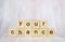 Macro shot of wooden cubes on a table showing the word YOUR CHANCE. Personal development and career growth or change