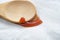 Macro shot of a wooden spoon with ketchup on white fabric texture. Cleaning dirty furniture concept.