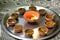 Macro shots of diyas being lit by hand or candle for the hindu religious festival of Diwali.