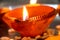 Macro shots of diyas being lit by hand or candle for the hindu religious festival of Diwali.