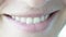 Macro smile. The girl with a closed mouth begins to smile