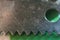 Macro steel knife on green