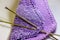 Macro texture background of hand knitted purple yarn cloth
