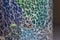 Macro texture of a mosaic pattern of colored glass pieces in ceramic ware