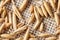 Macro unpeeled oat grains on burlap napkin background, top view, close-up, selective focus.