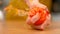 MACRO: Unrecognizable female chef with red nails squeezing an organic tomato.