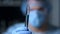 Macro video of doctor holding test tube in blue gloved hands.Protective mask.