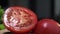 Macro video of the red juicy tomato cutted in a half, raw vegetables at the kitchen, close up food, isolated tomatoes on