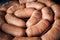 macro view on big pile of uncooked short thick sausages