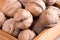 Macro view of a group of walnuts in a brown wooden box