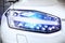 Macro view of modern car headlight SUV with noise graine effect. car xenon lamp headlight. detail view on car xenon lamp