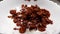 Macro view of pouring chocolate cornflakes in white bowl full of milk in slow motion