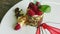 Macro view of sliced mousse raspberry dessert on white plate