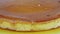 Macro view at sliced whole round homemade soft milk flan with caramel syrup