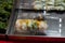 Macro view of steamed meat dumplings with salad in bowl.