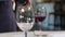 Macro Waiter Serves Visitors Pouring Red Wine into Wineglasses