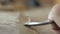 Macro. a woodcarver processes a walnut wood board with a chisel. craftsman makes a tea tray