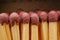 Macro of wooden matchsticks heads in open matchbox