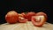 Macrography, slices of tomato placed on board with black background. Comestible.