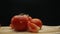 Macrography, slices of tomato placed on board with black background. Comestible.