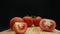 Macrography, slices of tomato placed on board with black background. Comestible.