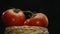 Macrography, tomatoes nestled within basket with black background. Comestible.