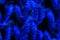 Macrophotography of blue knitted fabric.