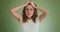 Mad angry woman in t-shirt holds head posing for camera