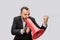 Mad and angry young person scream into red megaphone. He holds it with one hand and show fist with another one. It looks