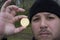 Mad bitcoin lover with a gold coin in your hand , funny miner with BTC near the face