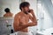 Mad topless man fighting while brushing teeth